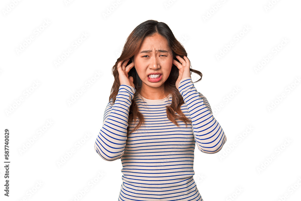 A young chinese woman covering ears with hands. A young chinese woman covering ears with hands.