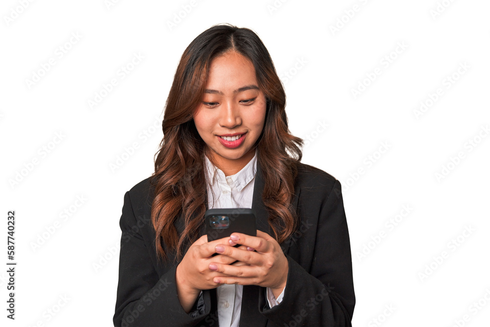 A young Chinese businesswoman looks happy while glancing at her phone, likely enjoying the convenience and connectivity of modern technology. A young Chinese businesswoman looks happy while glancing at her phone, likely enjoying the convenience and connectivity of modern technology.