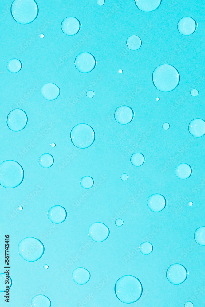 Bright pastel blue background with water and rain drops. Creative minimal concept of water and hydration.