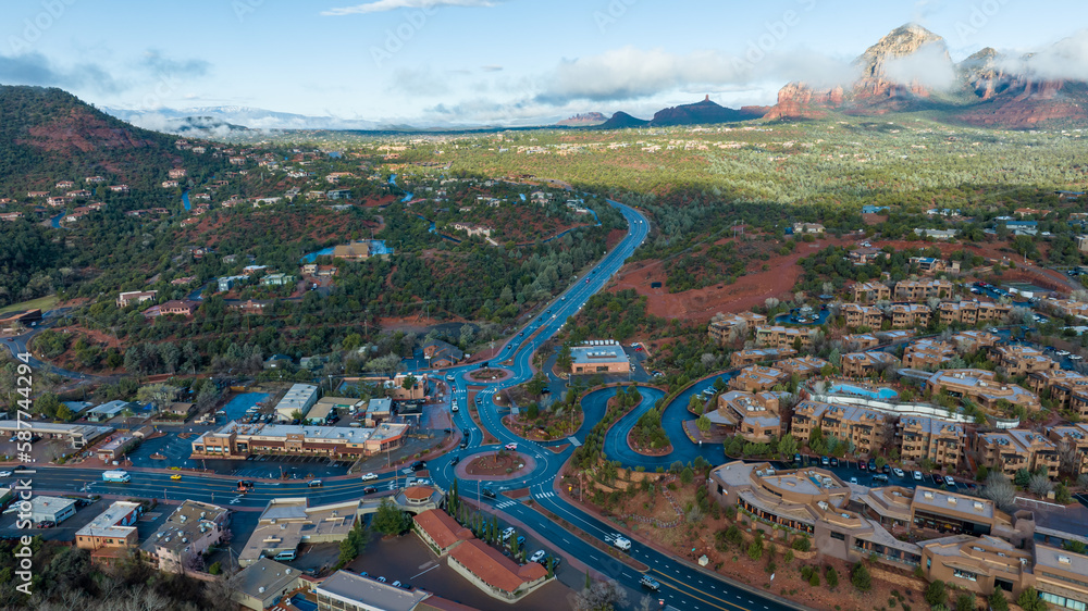 Aerial view of Sedona, Arizona with clouds covering some of the mountains.