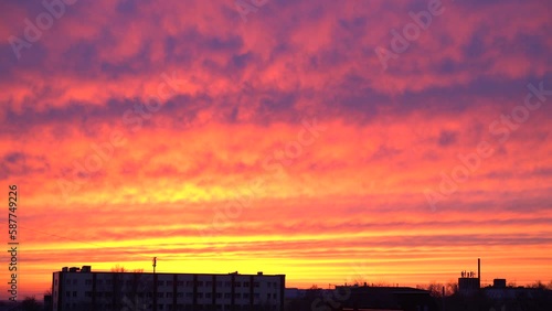 Beautiful evening blue sky at sunset with flaming bright light clouds. A warm summer evening at sunset. Bright sunset.