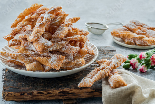 Traditional Italian carnival fritters dusted with icing sugar - frappe or chiacchiere photo