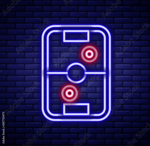 Glowing neon line Air hockey table icon isolated on brick wall background. Colorful outline concept. Vector