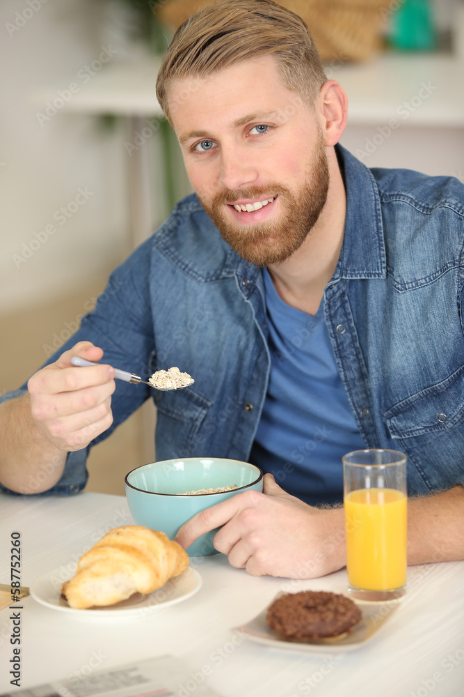 portrait of happy young man having healthy breakfast portrait of happy young man having healthy breakfast