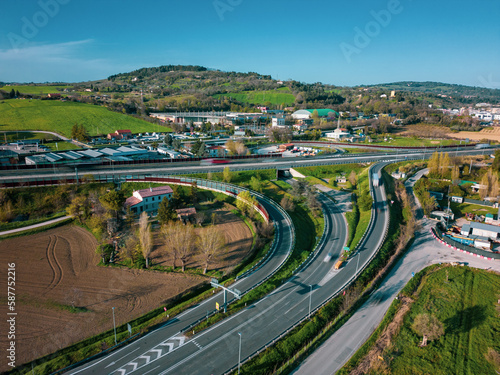 Aerial view over highway with moderate traffic and toll booth