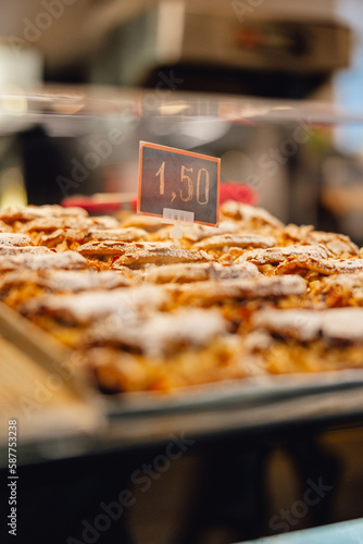 price sign display on tray of fresh baked European pastries in market cafe setting 1,50 1.50