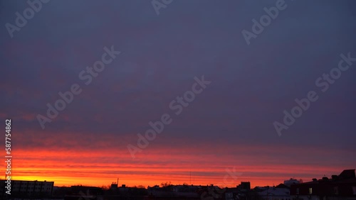 Beautiful evening blue sky at sunset with flaming bright light clouds. A warm summer evening at sunset. Bright sunset.