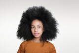 portrait of a young  mixed race girl with afro hairstyle on white background