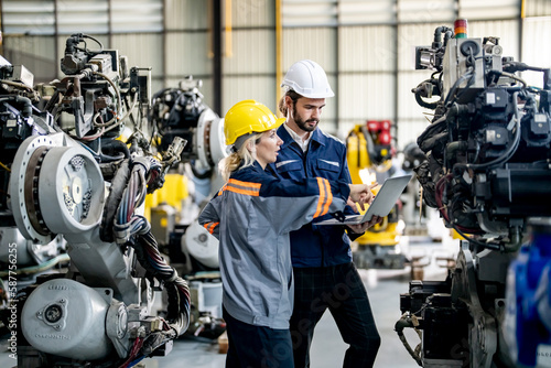 Industry 4.0: Engineer Monitoring Robotics Welding in Intelligent Factory. Digital manufacturing operation.