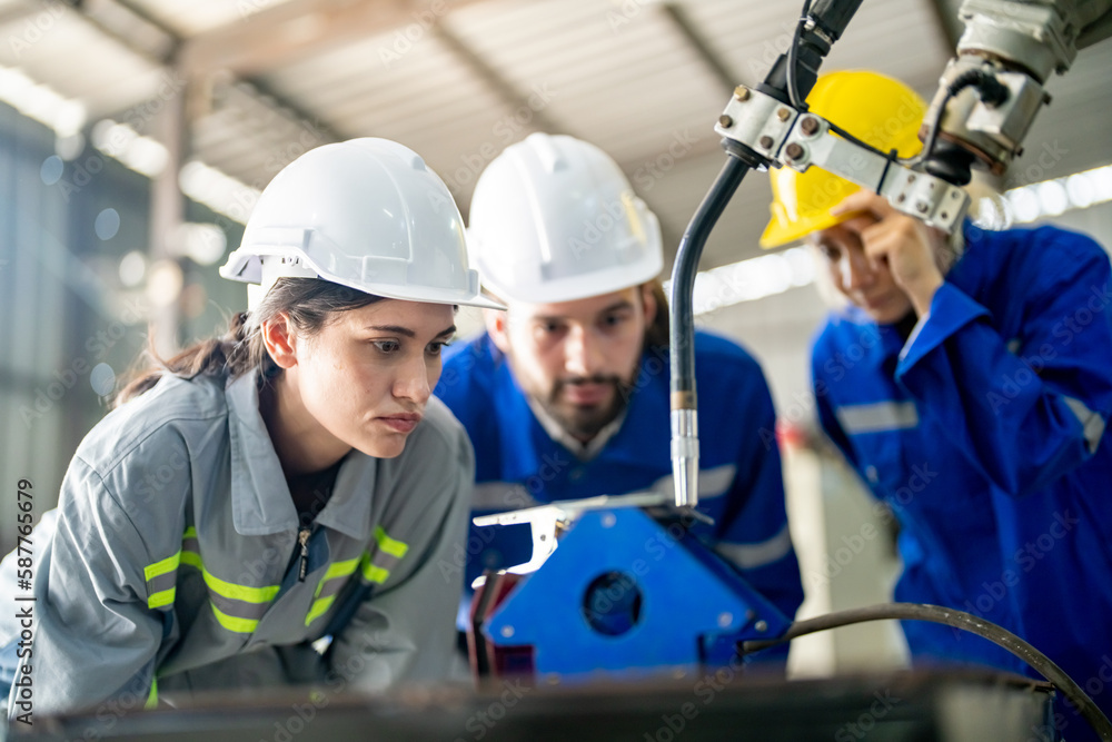 Engineer with robot in automotive parts factory Engineer with robot in automotive parts factory