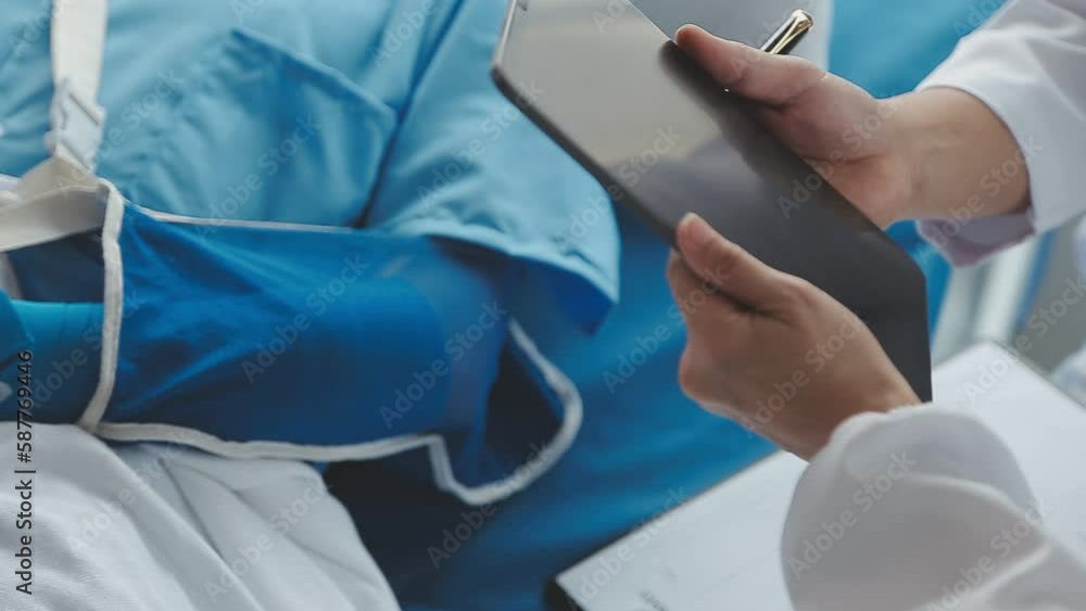 Man with broken arm in cast lying on bed in hospital. The emergency center treatment is plaster and hangs with sling for a further cure in an orthopedic clinic. Patient pain from accident injury. Man with broken arm in cast lying on bed in hospital. The emergency center treatment is plaster and hangs with sling for a further cure in an orthopedic clinic. Patient pain from accident injury.