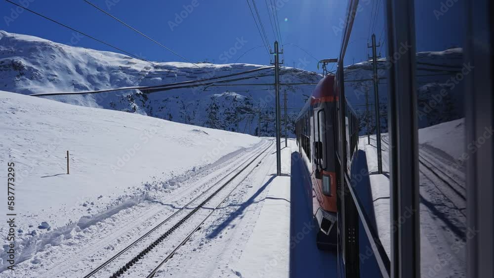 Riding the iconic cogwheel Gornergrat railway in Zermatt ski resort in the Swiss Alps in Valais, Riding a train in Switzerland on a sunny winter day Riding the iconic cogwheel Gornergrat railway in Zermatt ski resort in the Swiss Alps in Valais, Riding a train in Switzerland on a sunny winter day