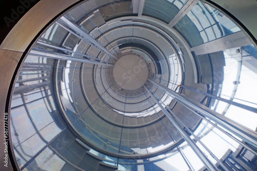 Futuristic uprisen angle view from the bottom to the top of spiral staircase