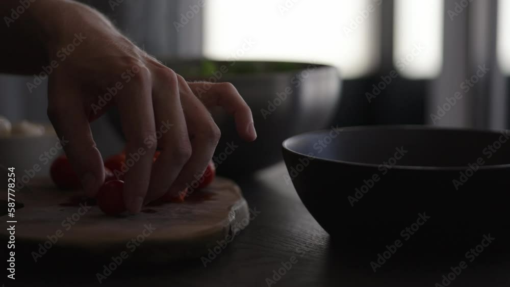 Slow motion man making salad in black bowl, cut tomatoes Slow motion man making salad in black bowl, cut tomatoes