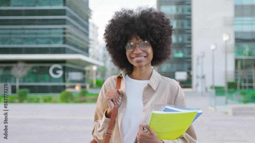 A portrait of African American girl with curly afro hairstyle stands ...