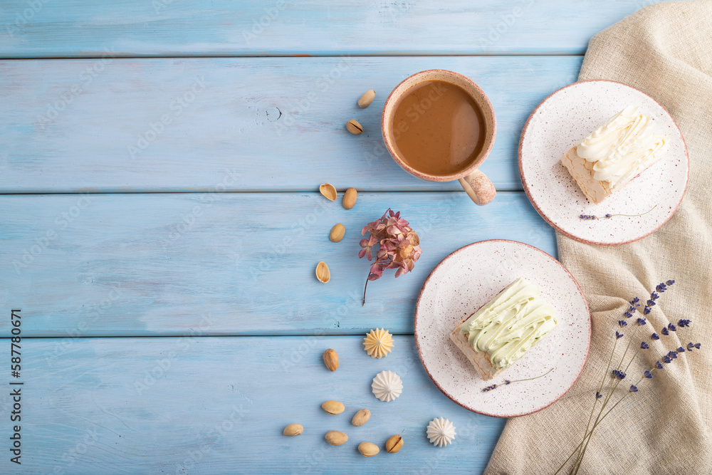 Roll biscuit cake with cream cheese and jam, cup of coffee on blue wooden, top view, copy space. Roll biscuit cake with cream cheese and jam, cup of coffee on blue wooden, top view, copy space.