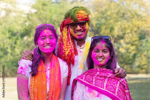Young indian Friends face coloured with gulal  during holi festival
