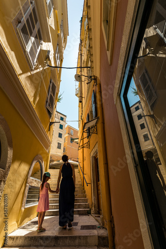 Woman and girl standing on a narrow streets of old Corfu town, Corfu, Greece