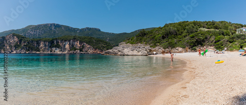 Panorama of beautiful Rovinia Beach with turquoise water and rocks during summer vacations, Corfu, Greece
