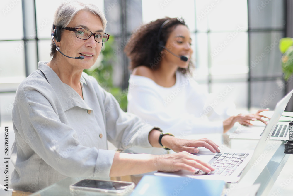 Fototapeta premium operator woman agent with headsets working in a call centre.
