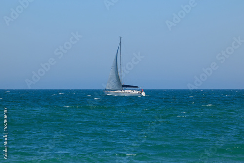 Blue Mediterranean Sea, clear skies and a sailing ship with white sailing. Regata