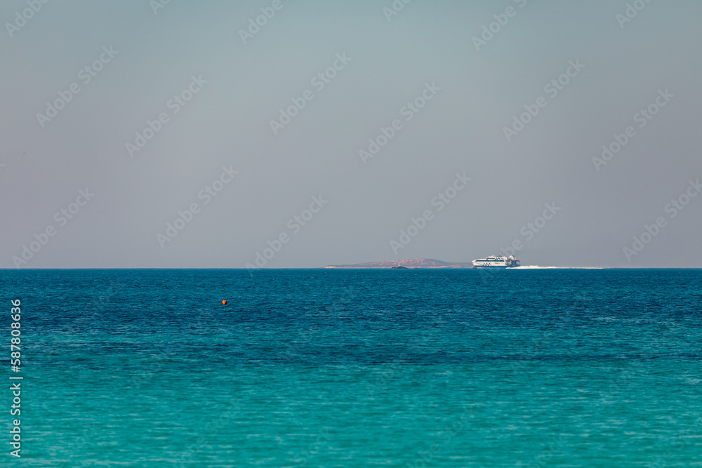 Speed boat on the horizon near harbour in Naxos Island, Greece, Europe