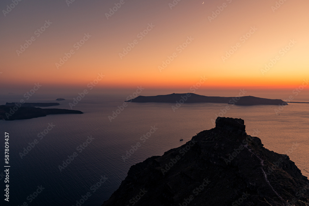 Santorini, Grece - July 23, 2020 -  Amazing red sunset over Oia and caldera of the Santorini island, Greece