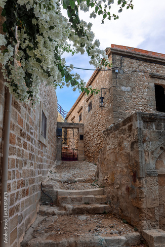 Street view of old town of Rhodes  Greece. Paved roads and pavements with colorful houses and fragrant flowers.