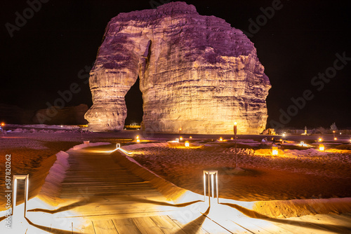 Illuminated sandstone elephant rock erosion monolith standing in the night desert, Al Ula, Saudi Arabia photo