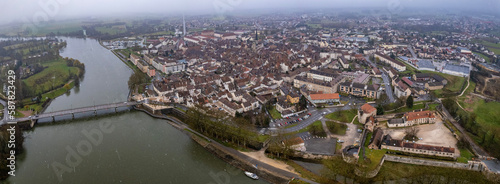 Aerial of the old town of Auxonne in early spring on a snowy morning in France