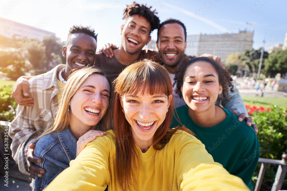 Group of happy friends posing for a selfie on a spring day as they party together outdoors. Group of multicultural friends having a good time together on the weekend. - obrazy, fototapety, plakaty 