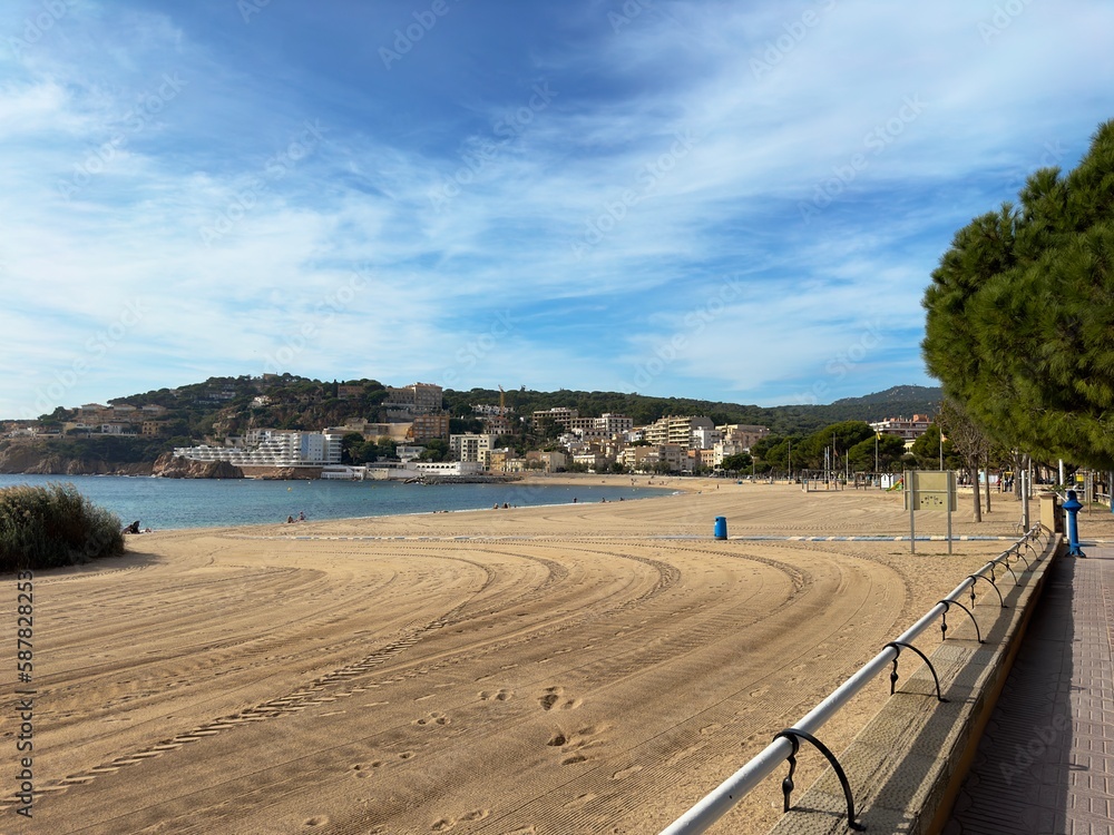 view of the city beach Platja de Sant Feliu in Sant Feliu de Guíxols towards the marina, Costa Brava, tourism