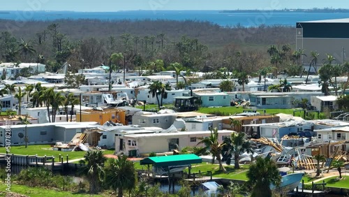 Badly damaged mobile homes after hurricane Ian in Florida residential area. Consequences of natural disaster photo