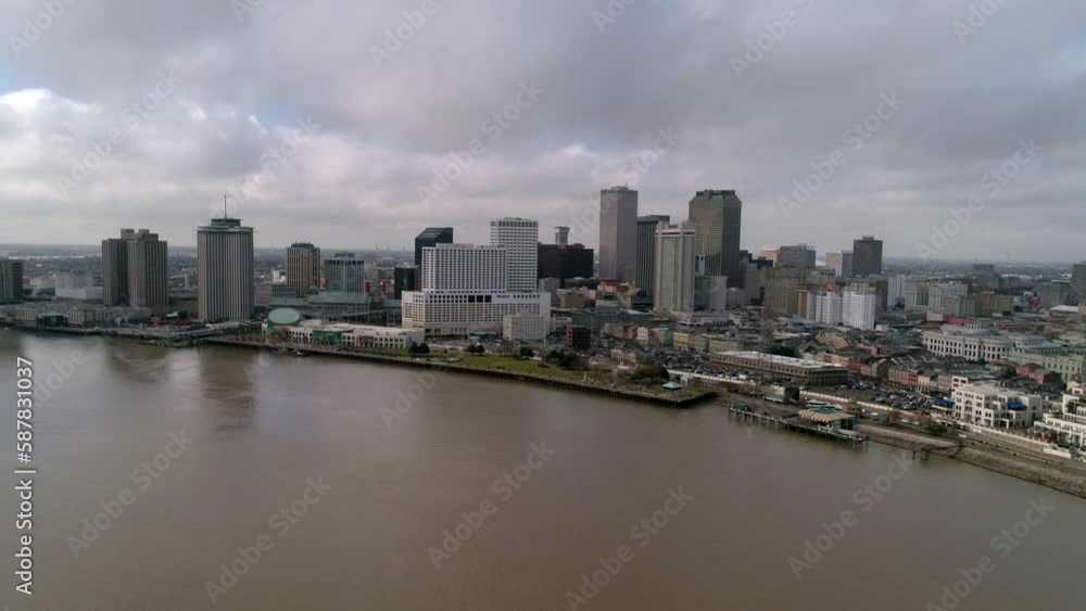 Aerial Panning Shot Of Modern Residential City Under Cloudy Sky, Drone Flying Backwards Over Famous River - New Orleans, Louisiana Aerial Panning Shot Of Modern Residential City Under Cloudy Sky, Drone Flying Backwards Over Famous River - New Orleans, Louisiana