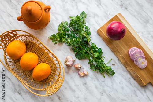 Oranges in a basket with cilantro - ingredients