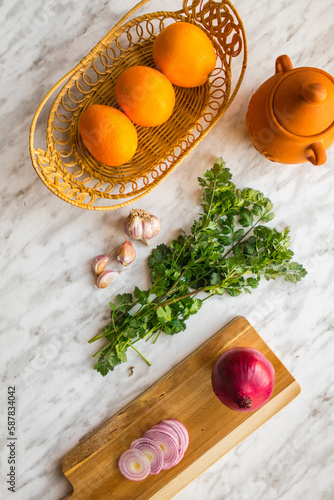 Oranges in a basket with cilantro - ingredients