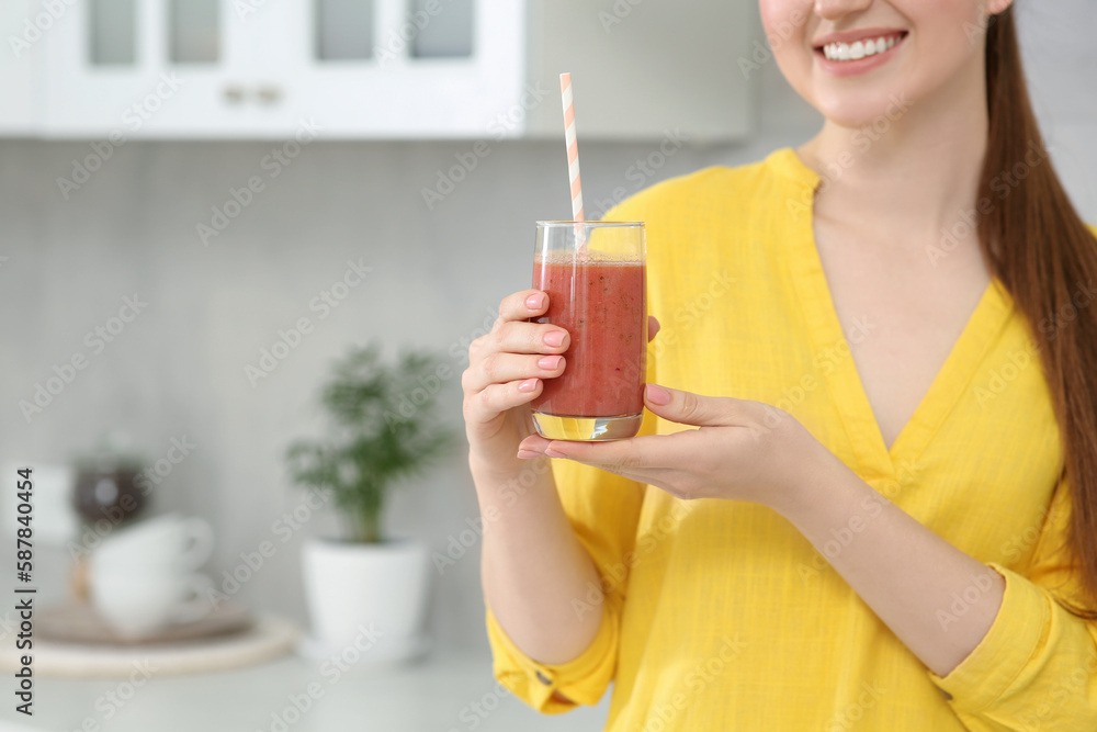 Woman with delicious smoothie in kitchen, closeup. Space for text Woman with delicious smoothie in kitchen, closeup. Space for text