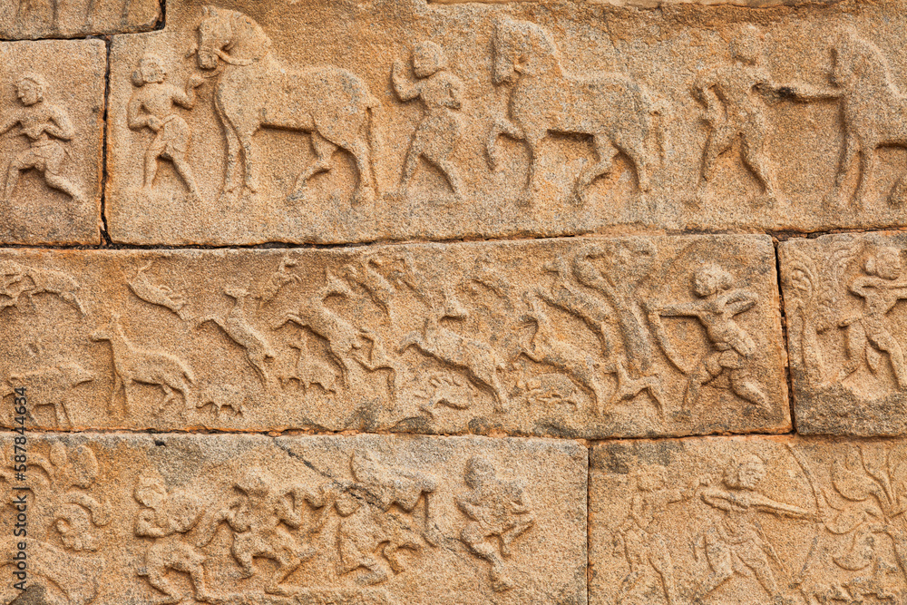 Intricate stone carvings and medieval artwork on the walls of Hazara Rama temple at Hampi, Karnataka, India