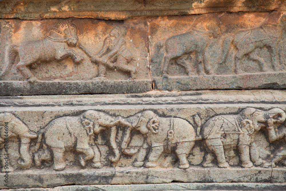 Medieval stone wall carvings of animals from ancient architecture ruins at the royal enclosure at Hampi, Karnataka India