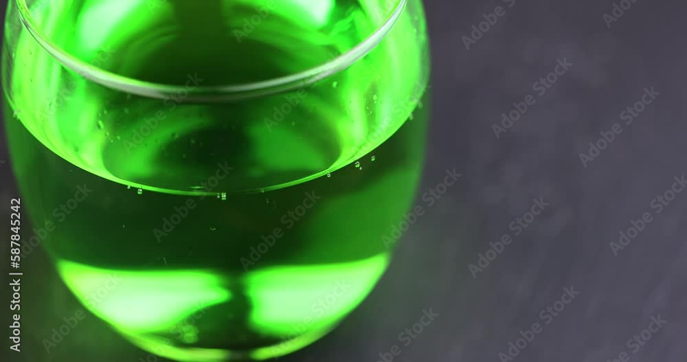 Green carbonated drink with gas on the table, green carbonated drink in a glass transparent glass Green carbonated drink with gas on the table, green carbonated drink in a glass transparent glass