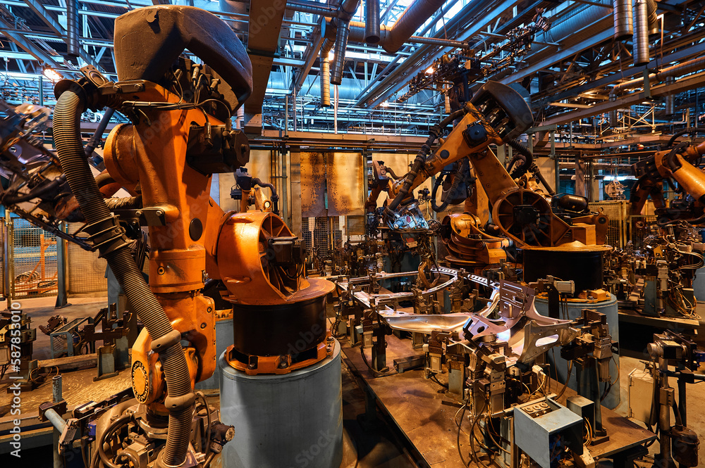 Contemporary robotic welding machines in plant workshop