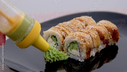 Japanese sushi sushimi on a white plate close-up, on a black background with ginger and wassabi. High quality photo photo