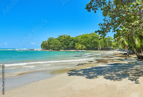 Bote en la bella playa de Puerto Viejo Costa Rica en un día de verano del caribe / Boat on the beautiful beach of Puerto Viejo Costa Rica on a Caribbean summer day photo