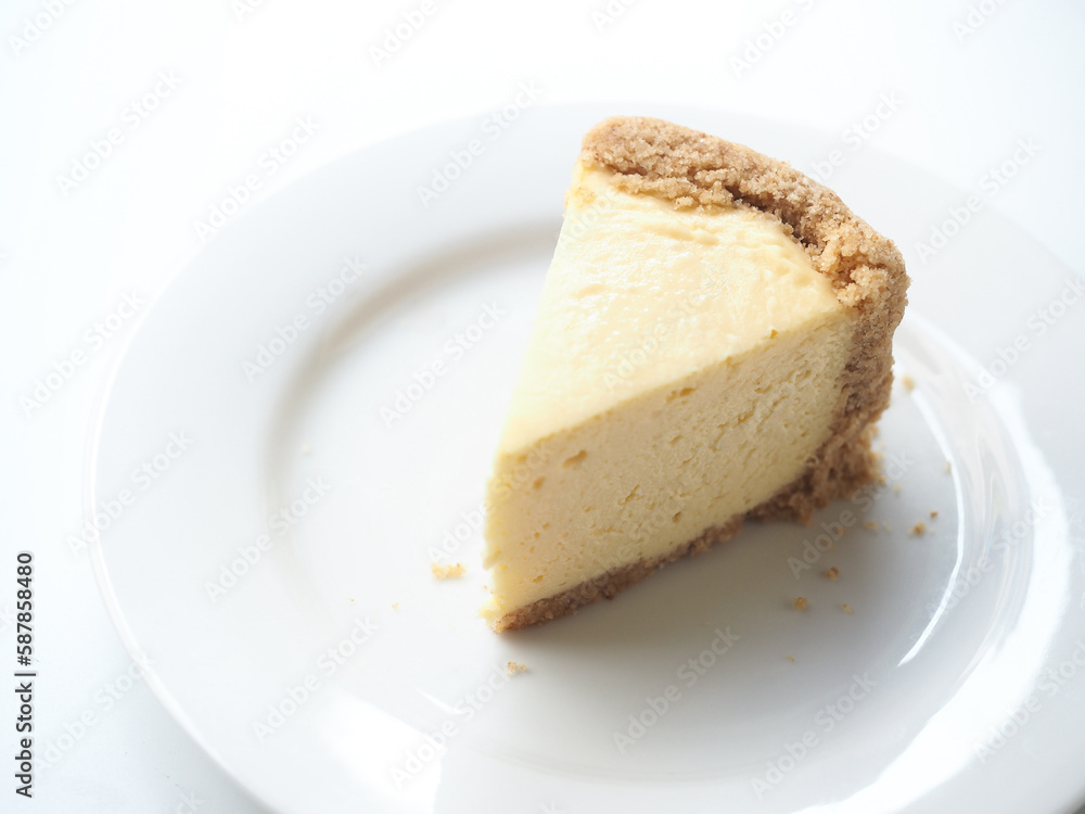 slice of mini New York cheesecake on white plate slice of mini New York cheesecake on white plate