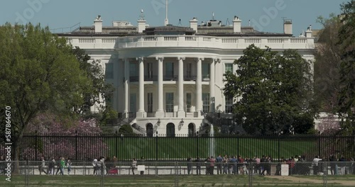 South View Of White House In Washington D.C. With Tourists Walking In Front, Seen From Ellipse Lawn
