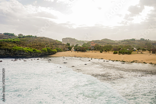 Yogyakarta, Indonesia March 2017 : Sarangan beach looks beautiful accompanied by waves coming from the Indian Ocean. photo