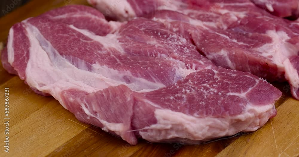 Preparation of a dish using pork meat, preparation of raw pork meat for cooking a meat dish,salting meat with sea salt Preparation of a dish using pork meat, preparation of raw pork meat for cooking a meat dish,salting meat with sea salt
