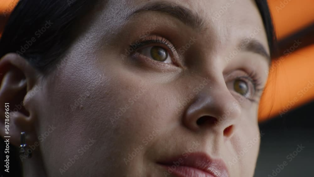 Detailed portrait of caucasian woman serious face with confident and deep look. Focused beautiful woman stares away, blinks eyes, poses on camera. LED lamps on the background in studio or office. Detailed portrait of caucasian woman serious face with confident and deep look. Focused beautiful woman stares away, blinks eyes, poses on camera. LED lamps on the background in studio or office.