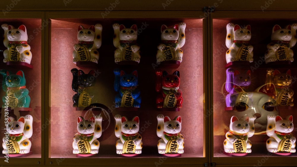 Low key lighting of Maneki neko in Tokyo, Japan.