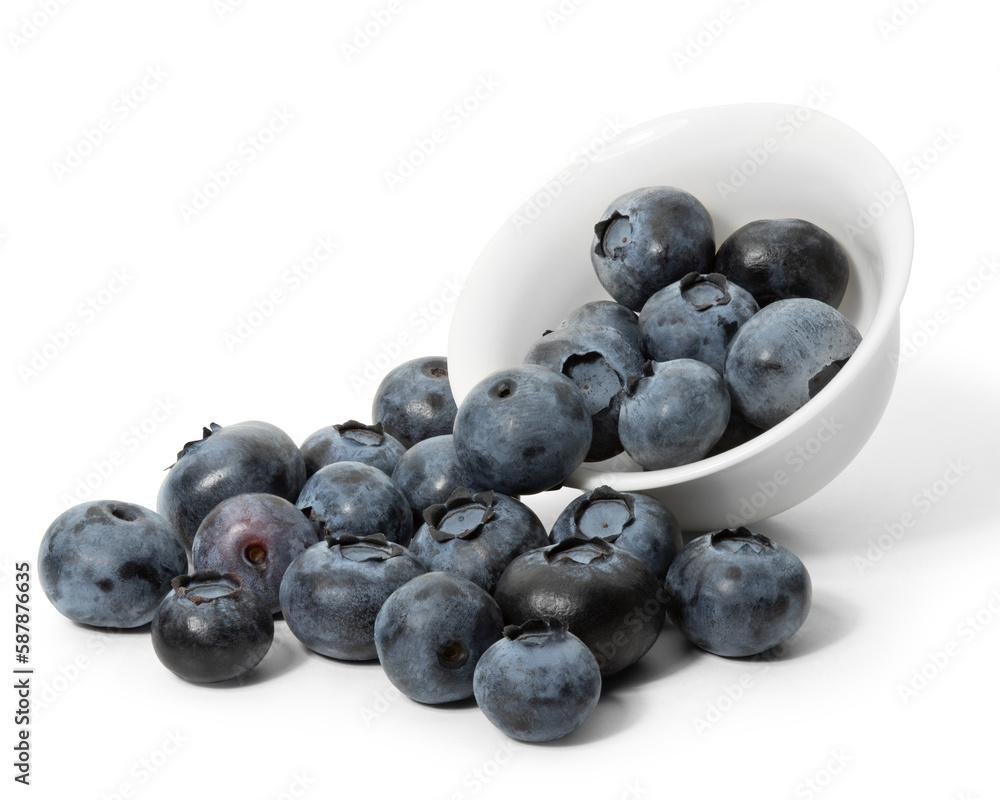 A lot of scattered blueberries from a white cup on a white background. Full depth of field. With clipping path. A lot of scattered blueberries from a white cup on a white background. Full depth of field. With clipping path.